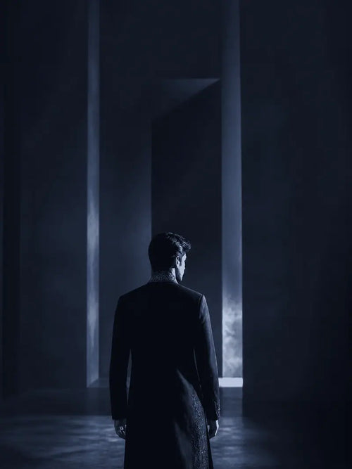Midnight Navy garment shown from behind in a gallery setting.