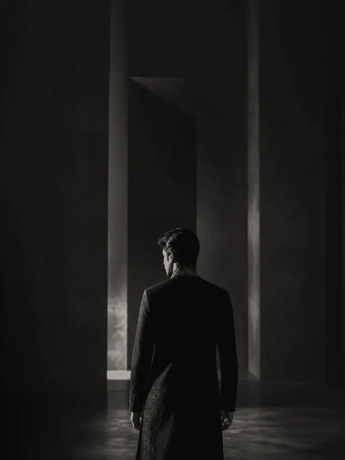 Onyx Black garment shown from behind in a gallery setting.