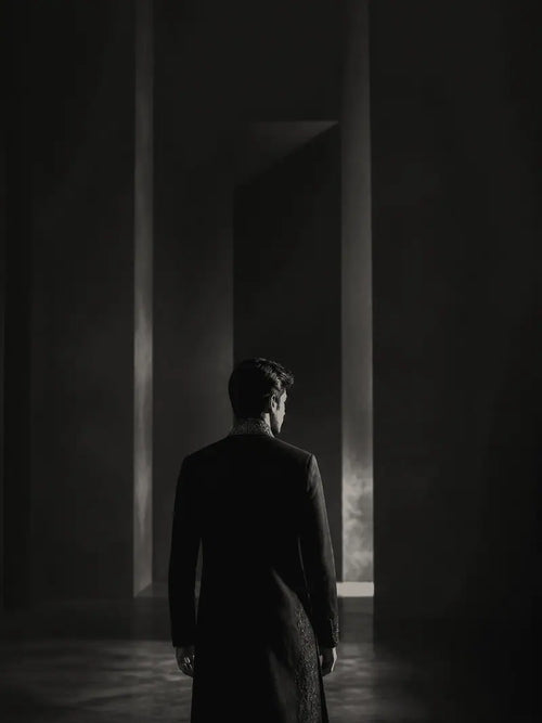Onyx Black garment shown from behind in a gallery setting.