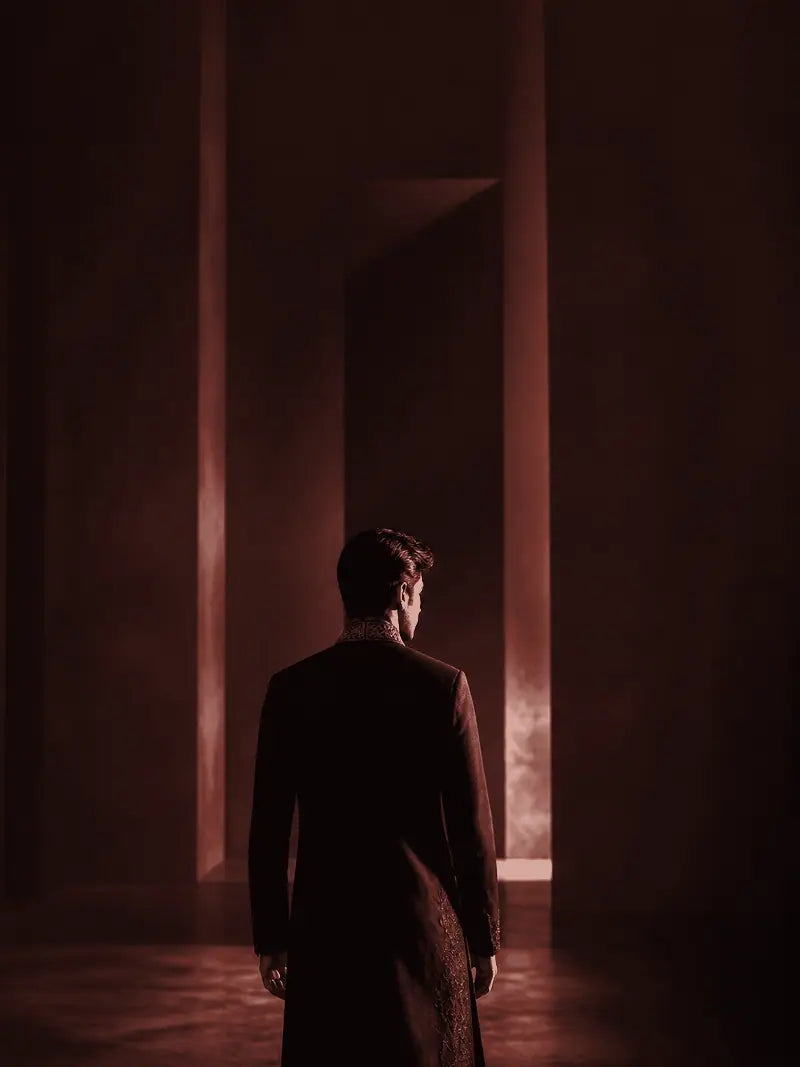 Maroon garment shown from behind in a gallery setting.